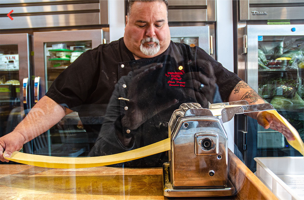 Our chef rolling out a fresh sheet of pasta